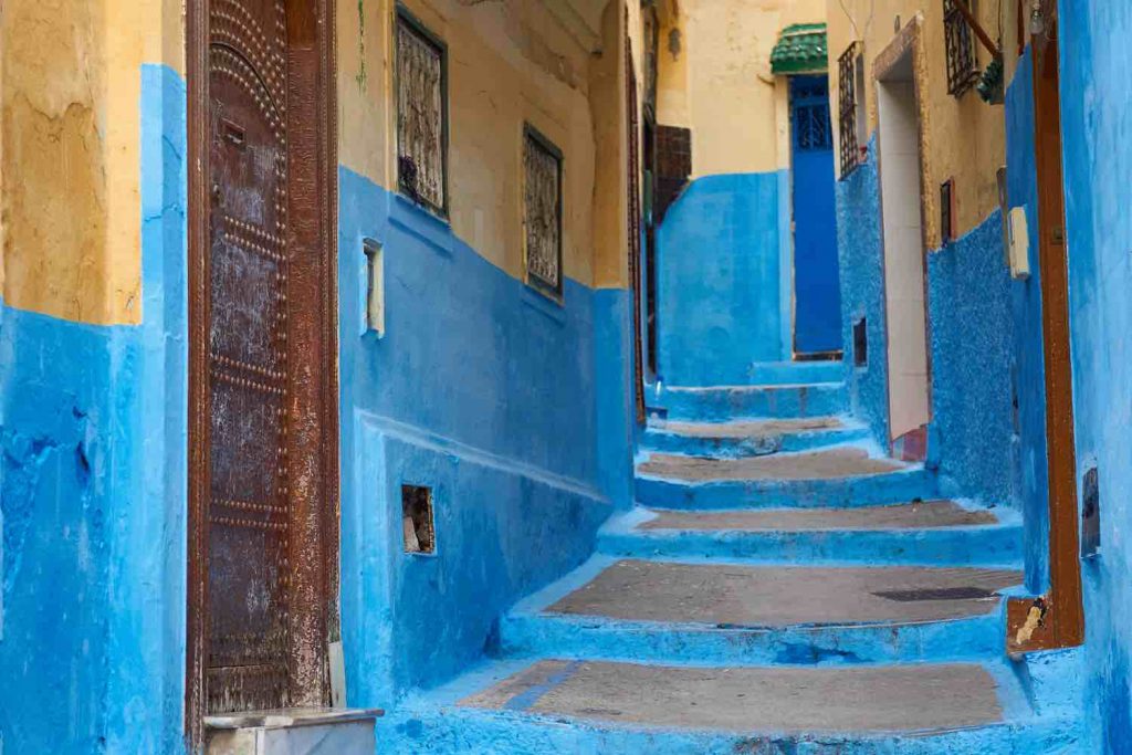 Ancient blue painted alley with old door entrance in the medina of Tanger (Tangier), northern Morocco.